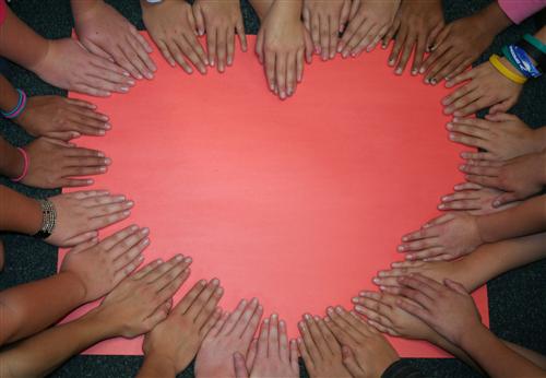 class heart made from kid hands